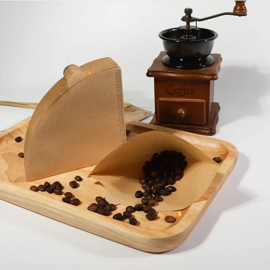 Here’s a rewritten version of the sentence using your product data: A stack of Coffee Paper Filters, [SIZE] [FILTER TYPE] Coffee Filters ([NUMBER OF FILTERS] Pack, [MATERIAL], compatible with [COFFEE MAKER / DRIPPER / BREWER]), along with coffee beans, a manual coffee grinder, and a wooden tray are arranged on a white surface.